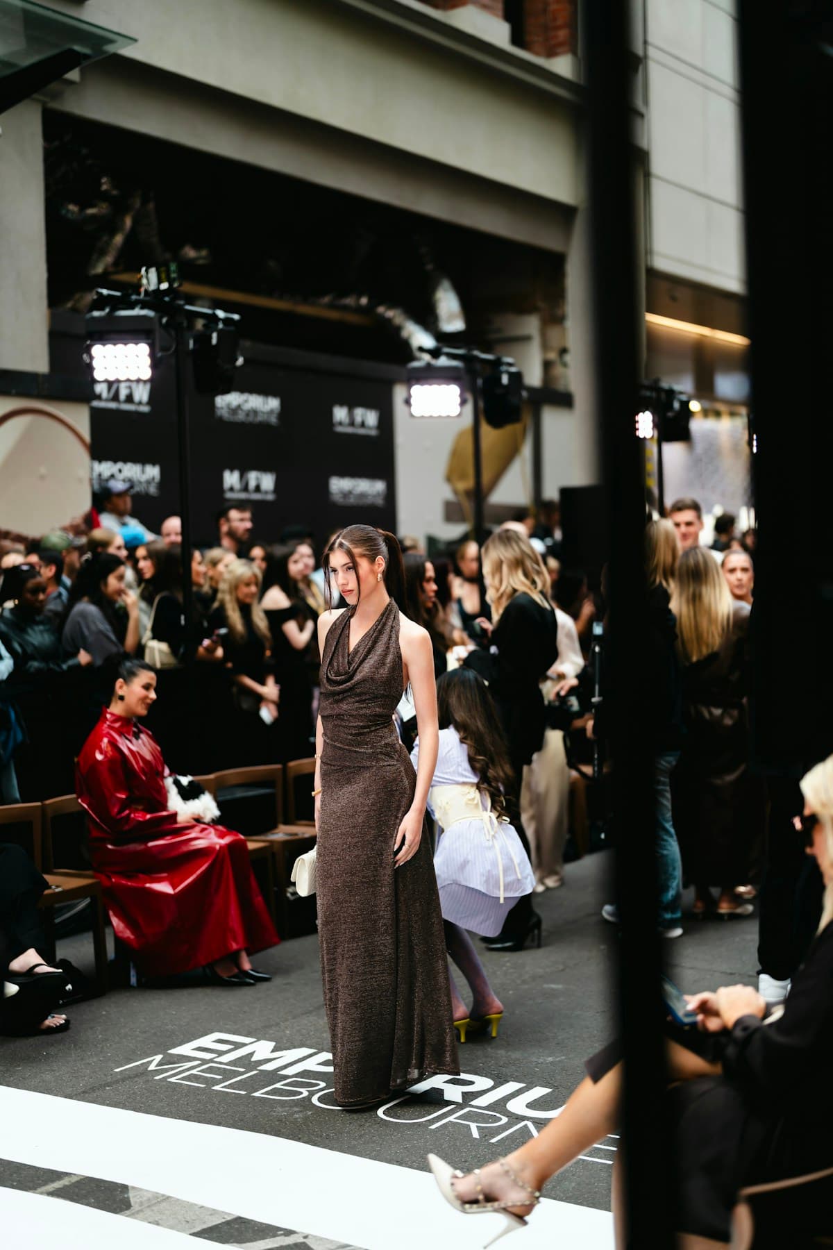 Model on the catwalk with audience at a fashion event