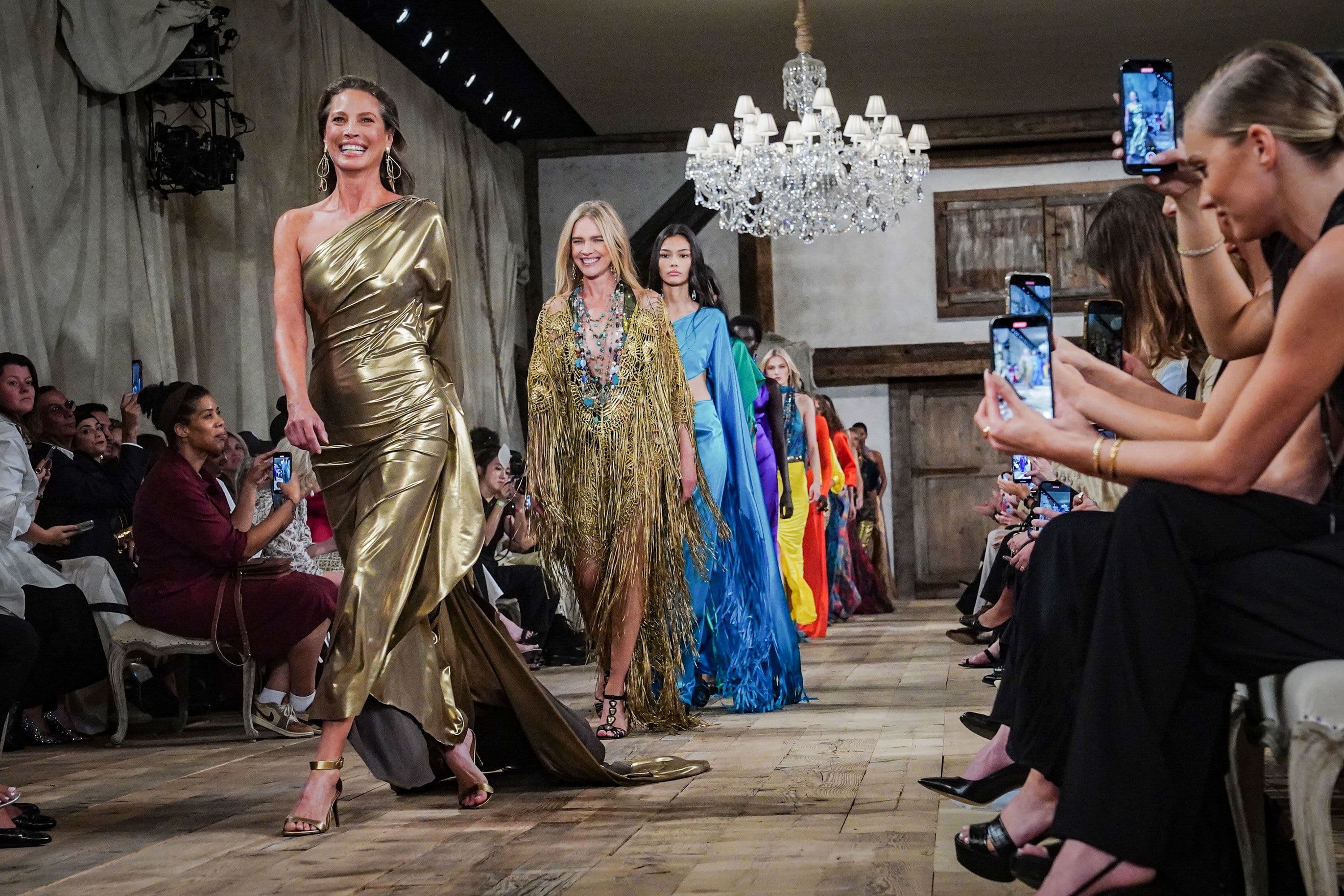 Models walking the runway in metallic gowns at a New York Fashion Week show